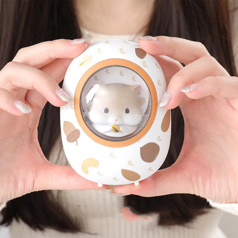 White Hamster hand warmer power bank with space capsule design showing charging port and heating controls