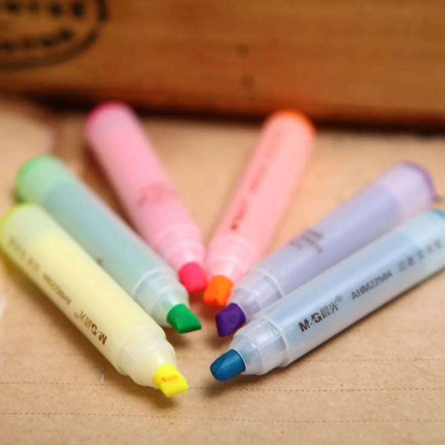 Set of six plastic highlighter pens with oblique chisel tips in different fluorescent colours.