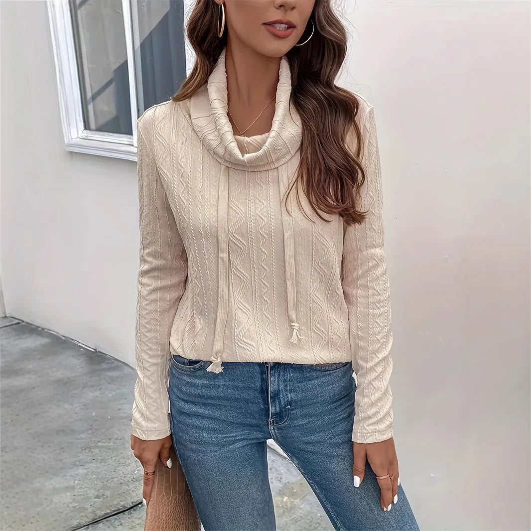 Apricot coloured long sleeve hooded pullover sweater on a hanger, showing the drawstring and solid colour.