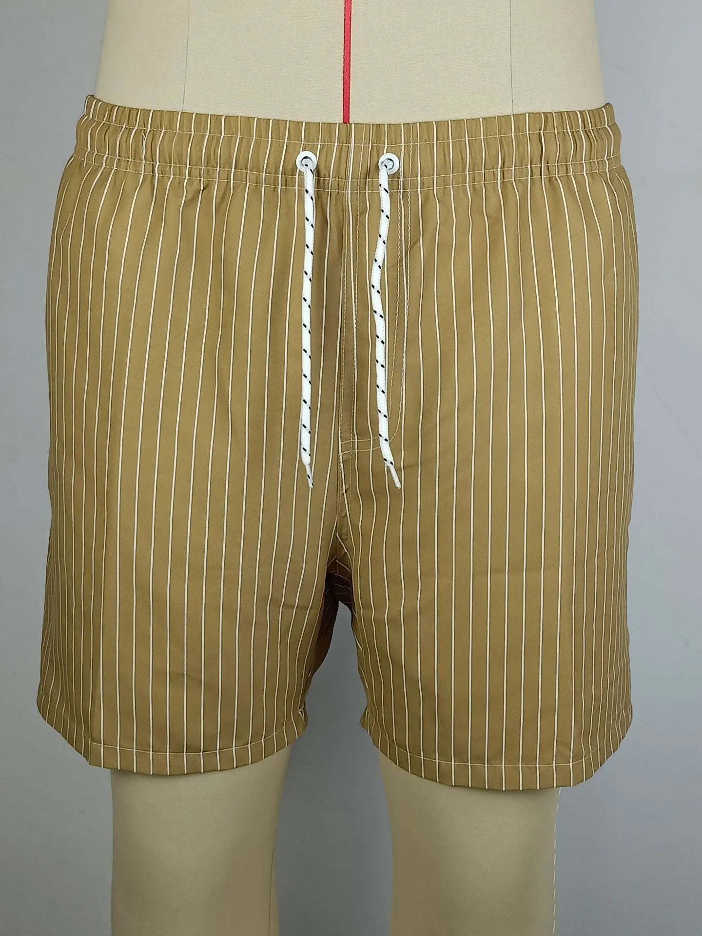 Men's navy blue and grey striped beach shorts with straight legs and built-in lining, laid flat.