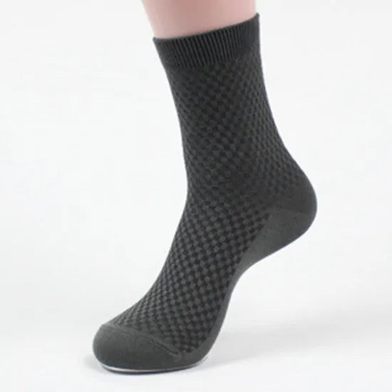 Men's bamboo fibre business socks in grey with a small-square pattern, shown on a foot.