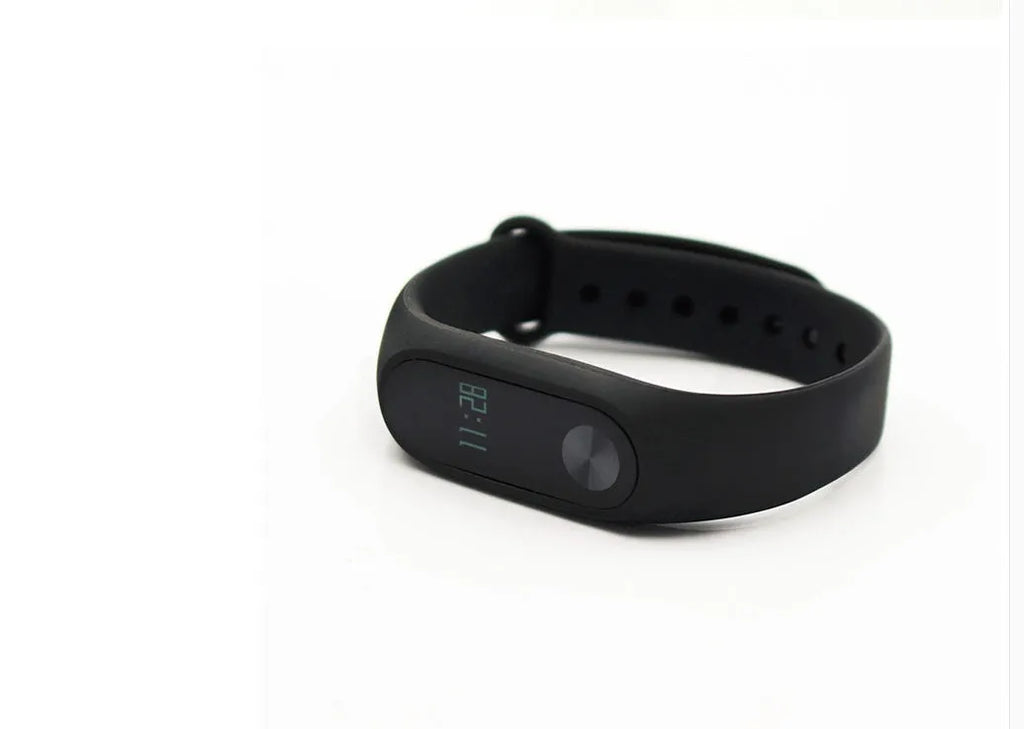 Xiaomi Mi Band 2 black fitness tracker on wrist showing OLED screen display.