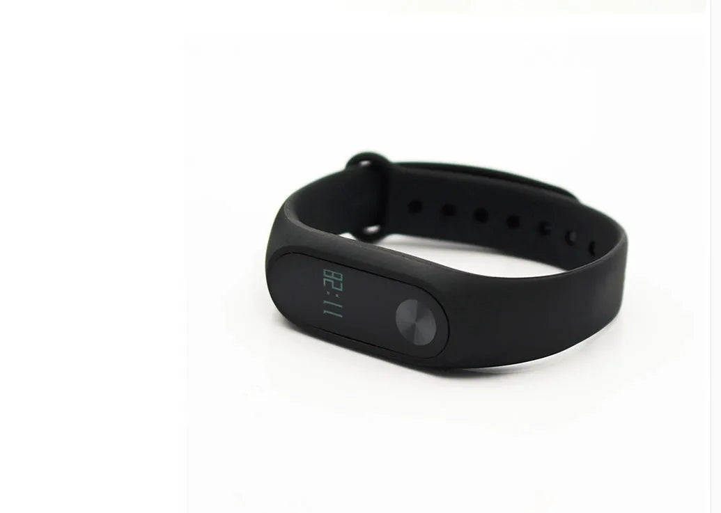 Xiaomi Mi Band 2 black fitness tracker on wrist showing OLED screen display.