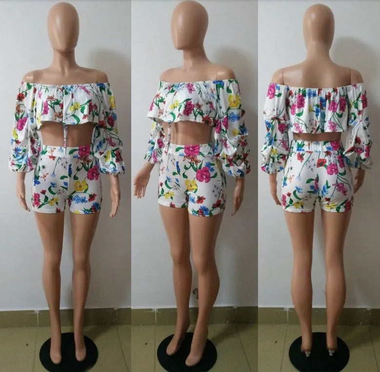 Women's multicolour printed tracksuit set with fleece sleeves on the top and matching shorts.
