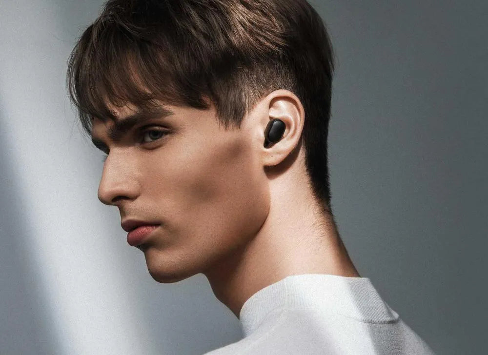 Redmi AirDots black true wireless Bluetooth headphones and charging case.
