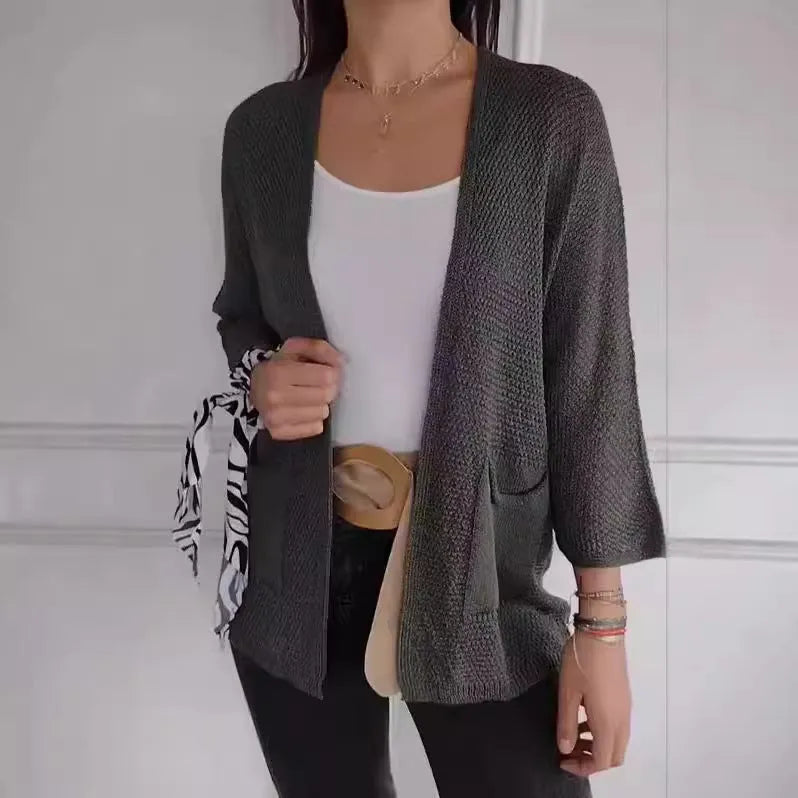 Women's army green waffle knit cardigan coat with nine-quarter length sleeves and pockets.