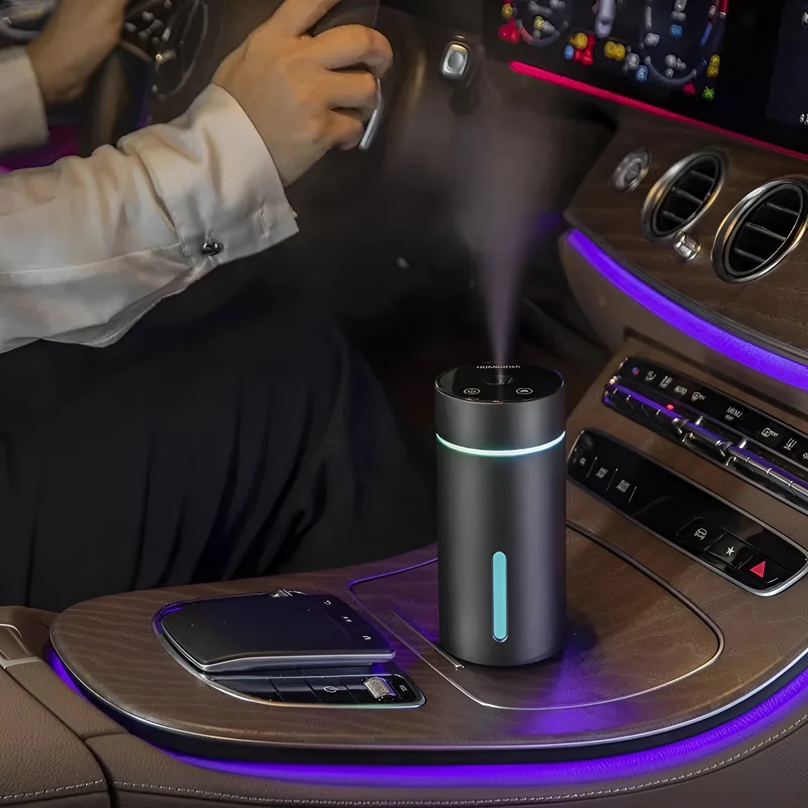 Compact aluminium car humidifier diffuser with colourful light and USB cable on a desk.