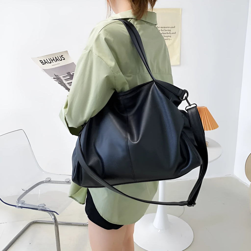 Large khaki soft PU messenger bag with long strap, shown open with internal phone and zipper pockets.