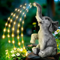 Resin elephant garden statue with built-in LED light strip for outdoor decoration.