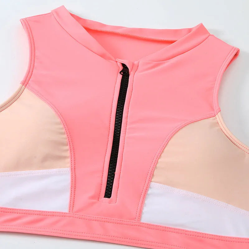 Pink high waist bikini swimsuit with briefs and a bra on a neutral background.