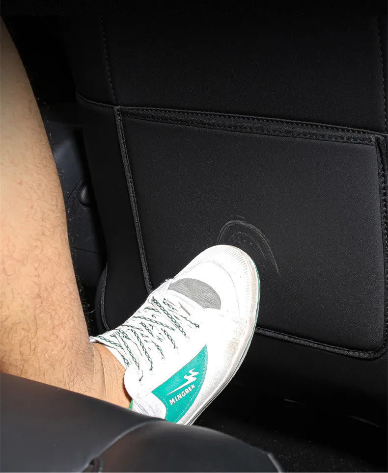 Two black leather rear seat anti kick pads showing full coverage design and single pocket style.
