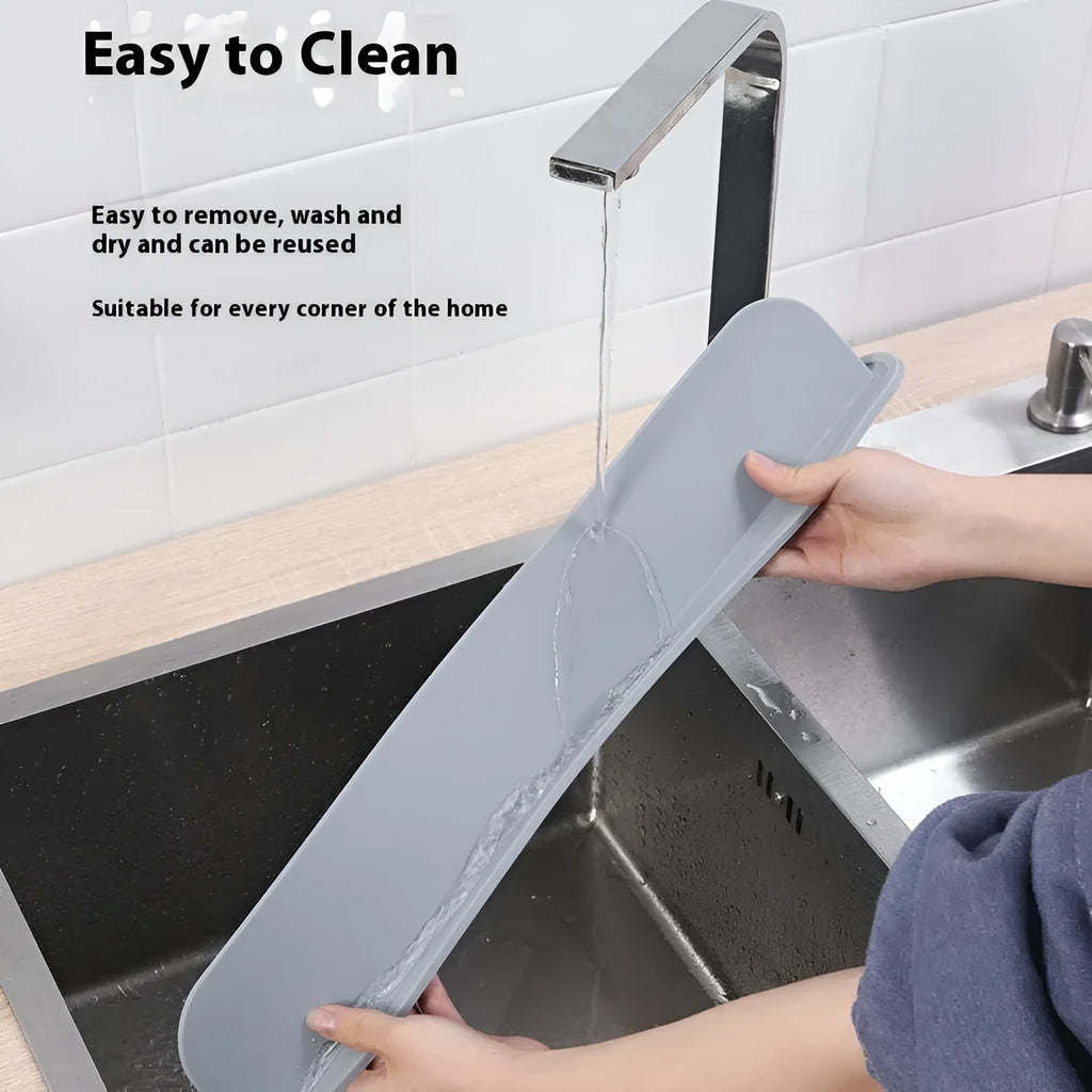 A grey silicone sink water blocking plate measuring 52mm by 85mm.