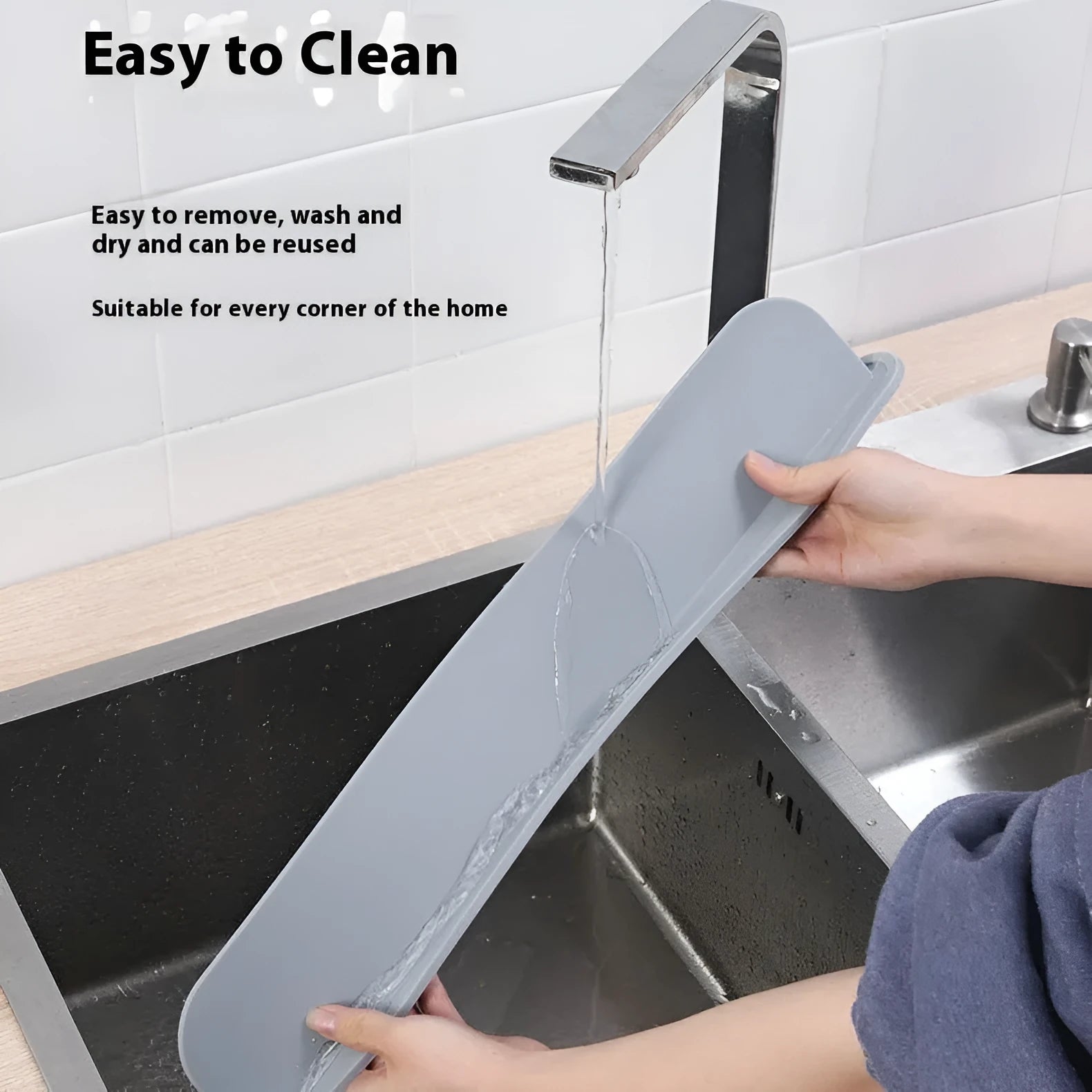 A grey silicone sink water blocking plate measuring 52mm by 85mm.