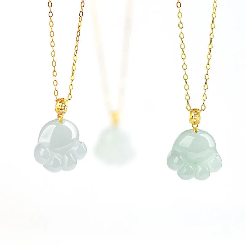 Emerald light green jade cat's paw pendant with 18K gold buckle and certificate on a white background