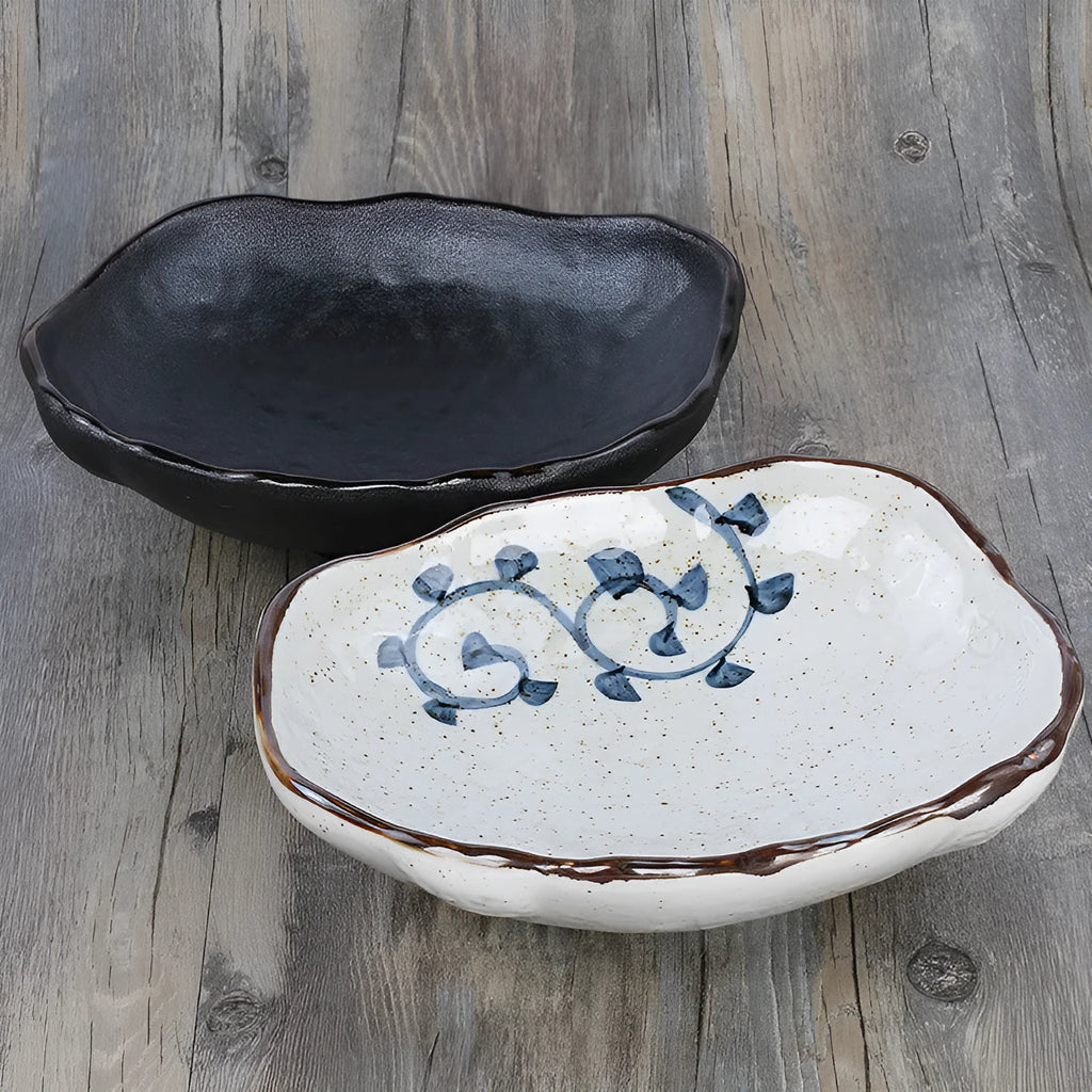 Japanese style irregular shaped ceramic sashimi bowl with floral decoration and sauce dish