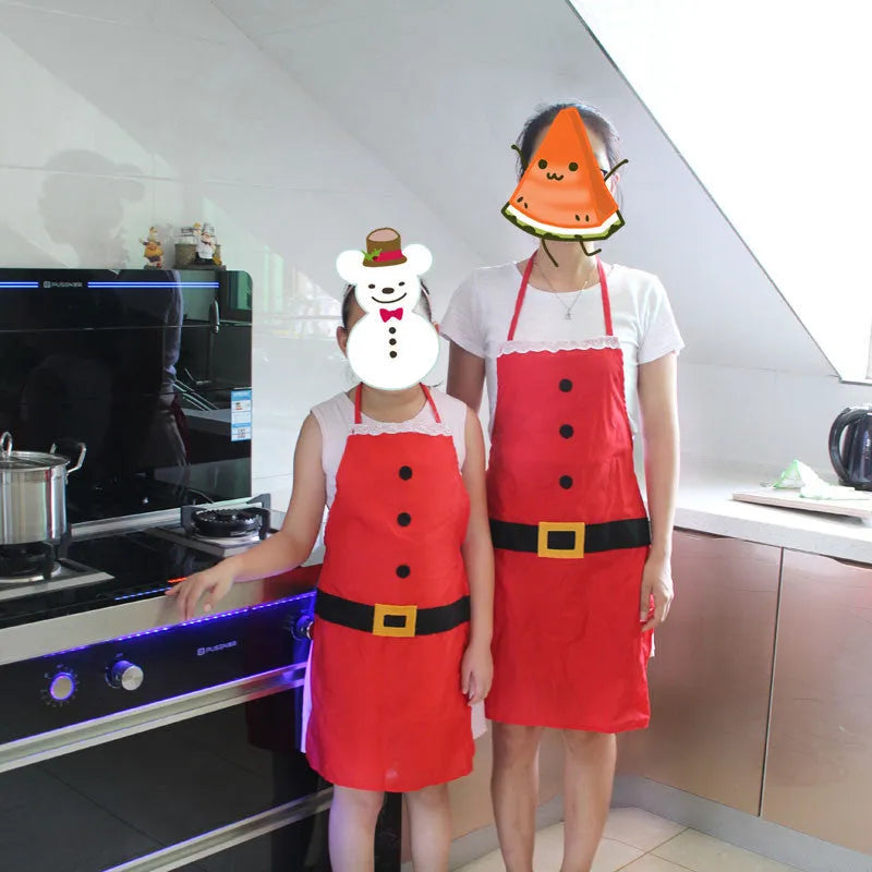 Red Christmas apron with 'Merry Christmas' text for adults and children in kitchen setting