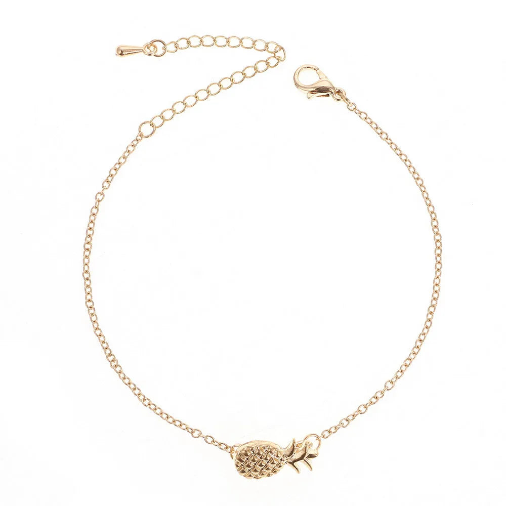 Close-up of a women's alloy bracelet featuring a detailed pineapple charm in gold or silver colour.