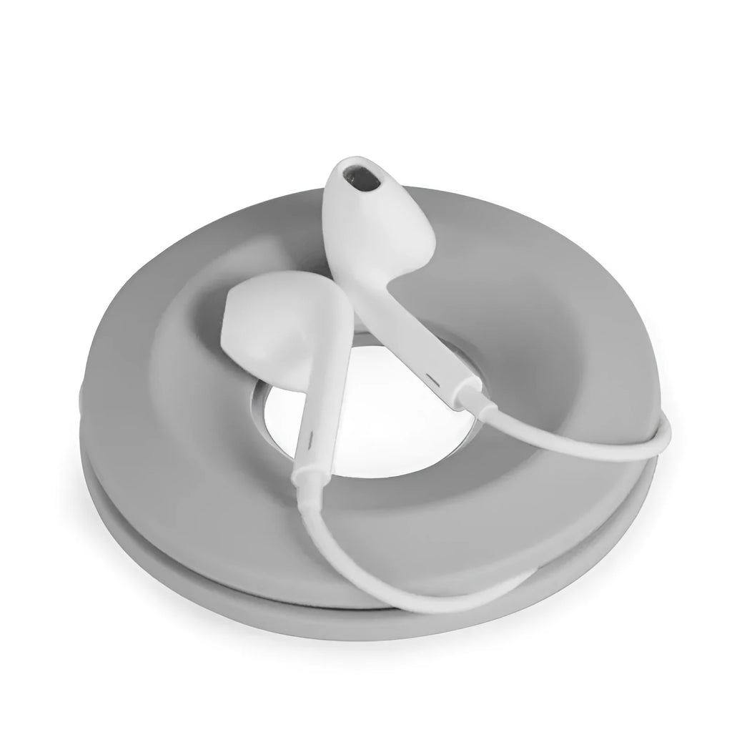 Donut-shaped silicone cord reel in three colours for organising headphones and phone cables