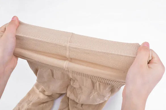 Women's high-waisted seamless shapewear shorts in black on a mannequin, showing tummy control design.