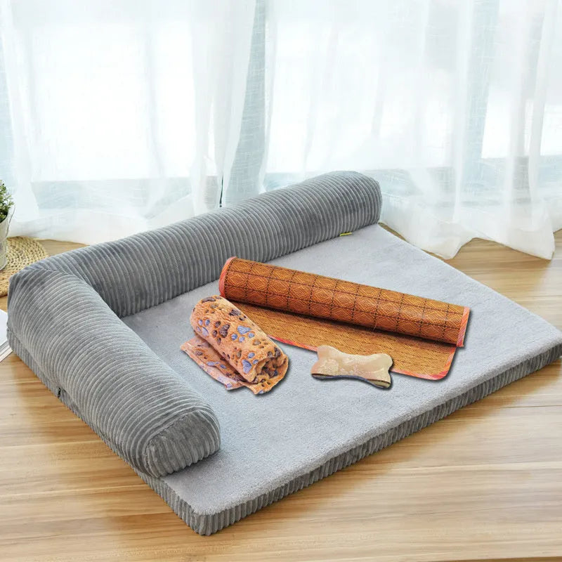 Grey corduroy pet sofa dog bed with bilateral bolsters and a non-slip cloth base on a wooden floor.