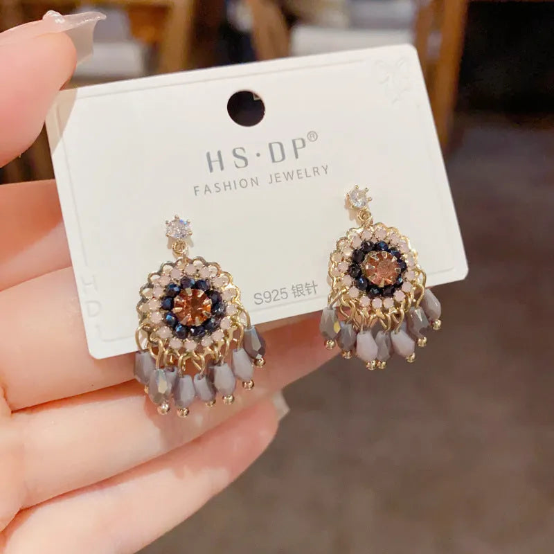Round crystal tassel earrings with diamond embedded design in thick gold plated copper