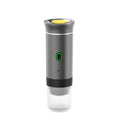 White portable espresso machine with grinder, showing capsule compartment and USB charging cable