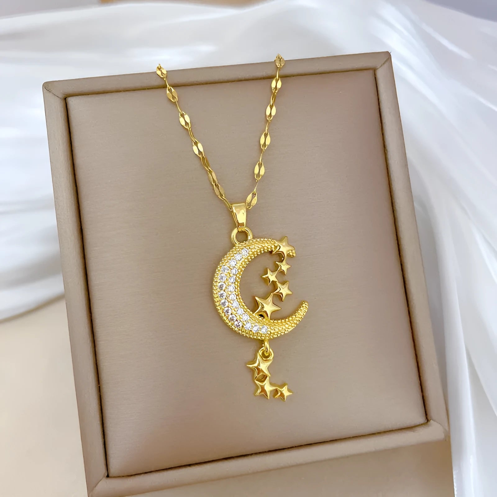 Geometric moon tassel necklace with diamond detail on a stainless steel chain.