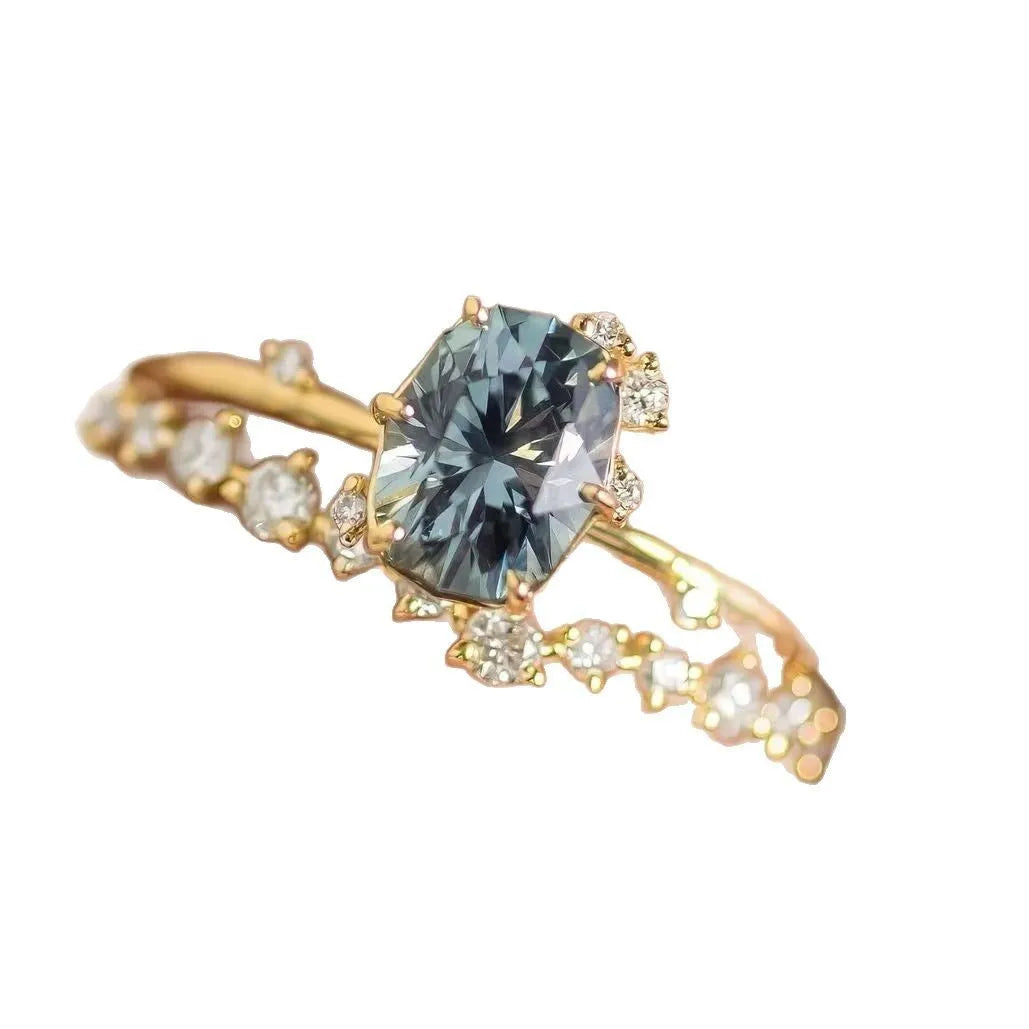 Gold plated women's ring with a green zircon stone set in a flower-shaped alloy band.