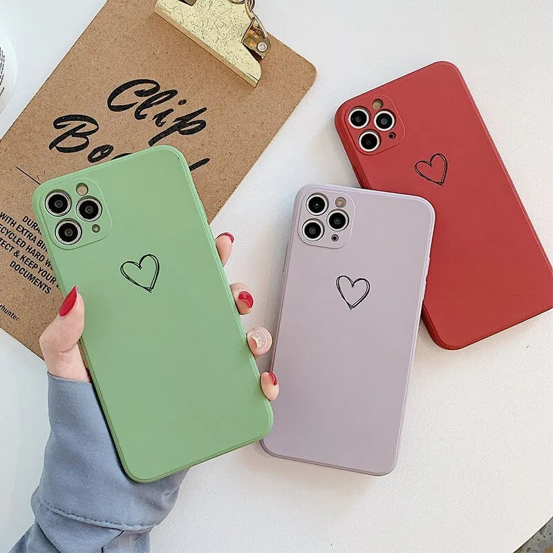 Solid colour silicone phone case for iPhone shown in black, green, grey, light green, pink, purple, red, and white options