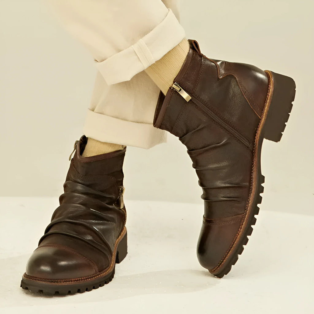 Men's black high-top cowboy boots with side zip and round toe on a plain background