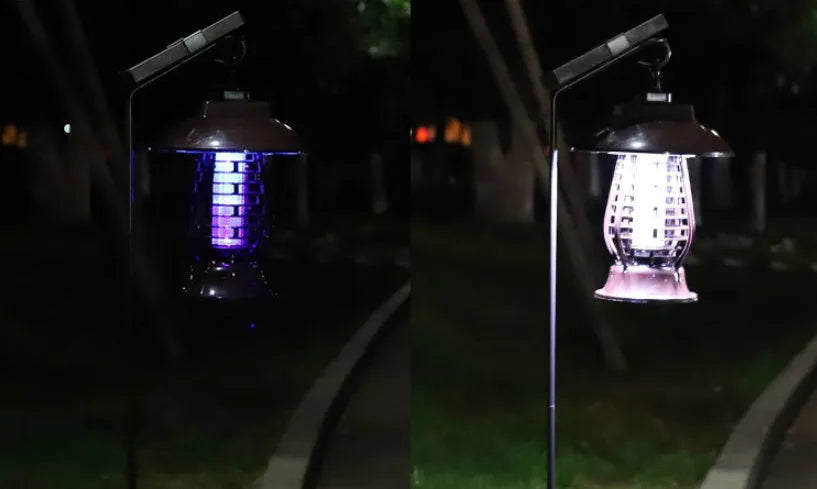 White outdoor solar mosquito lamp with solar panel on top and LED light beads, shown in a garden setting.