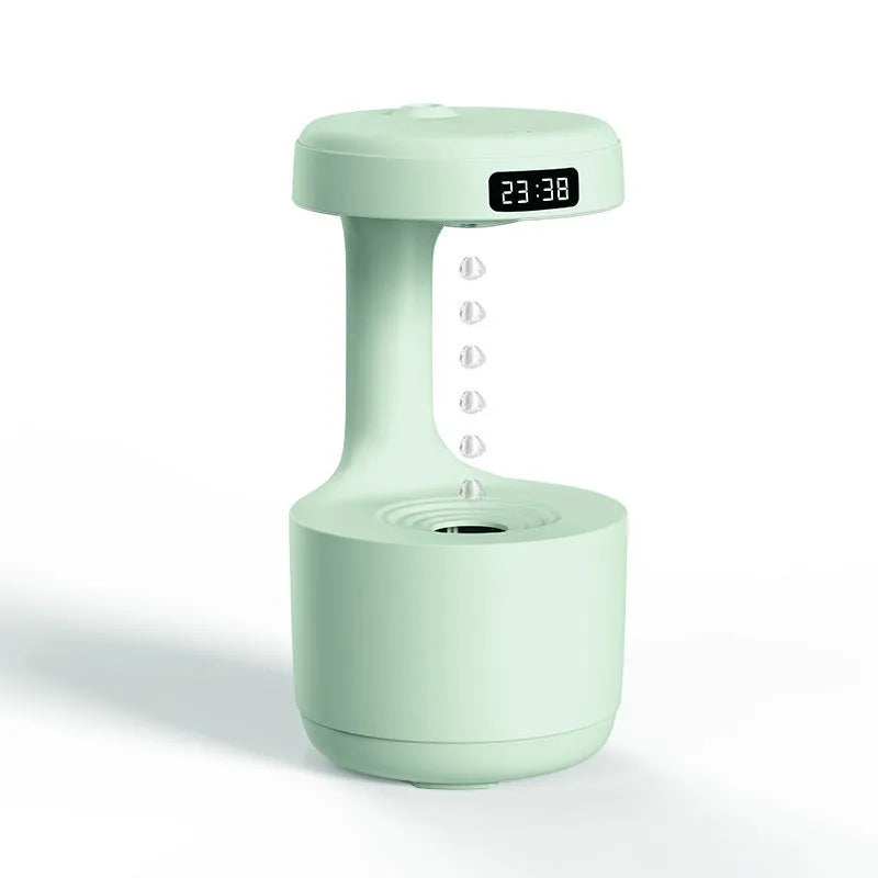 Rose gold and white levitating water drops humidifier with LED light on desk