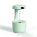 Rose gold and white levitating water drops humidifier with LED light on desk