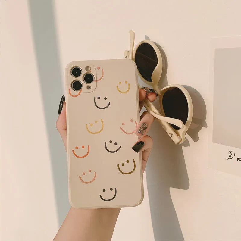 Simple TPU iPhone case with painted smiley face design in three colour options
