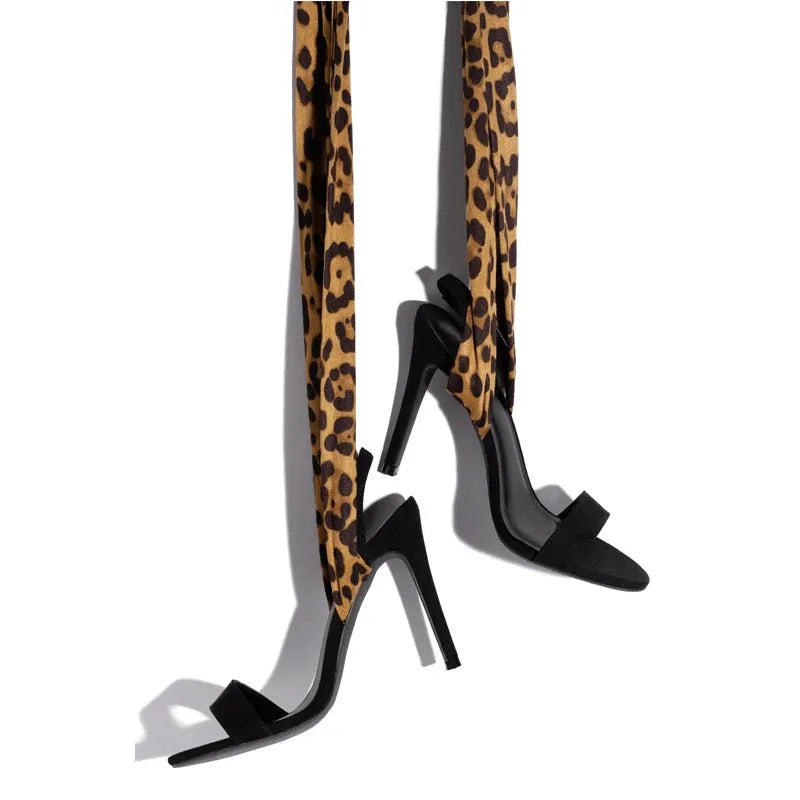 Light brown leopard print women's high heel sandals with crossover straps and a thin stiletto heel.