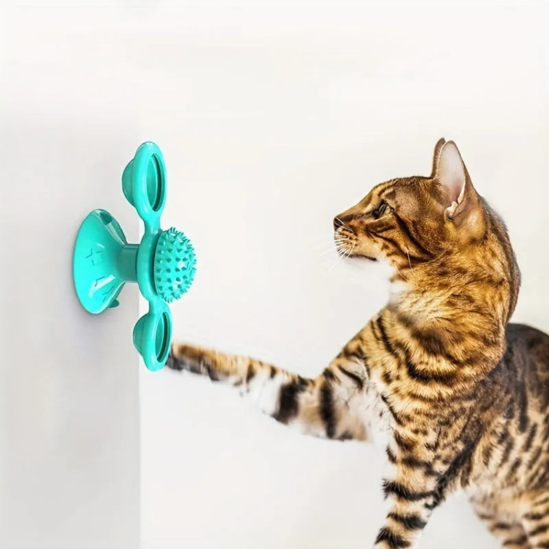 Rotating windmill cat toy with LED light and catnip balls on a white wall