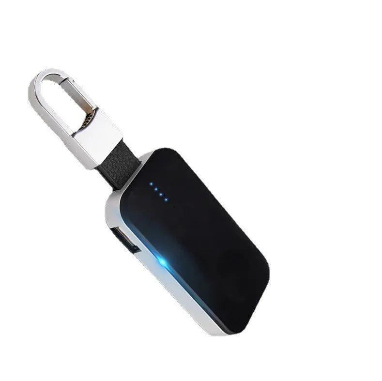 Black portable wireless power bank charger for Apple Watch on a keychain.