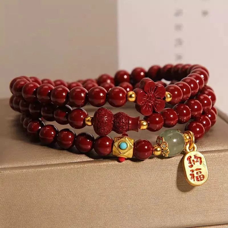 Red cinnabar bracelet with 6mm beads showing multi-circle gourd and five petal flower geometric design