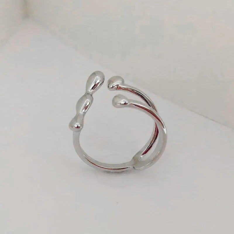 Brass ring with a spherical design on a circular band, shown in gold and silver finishes.