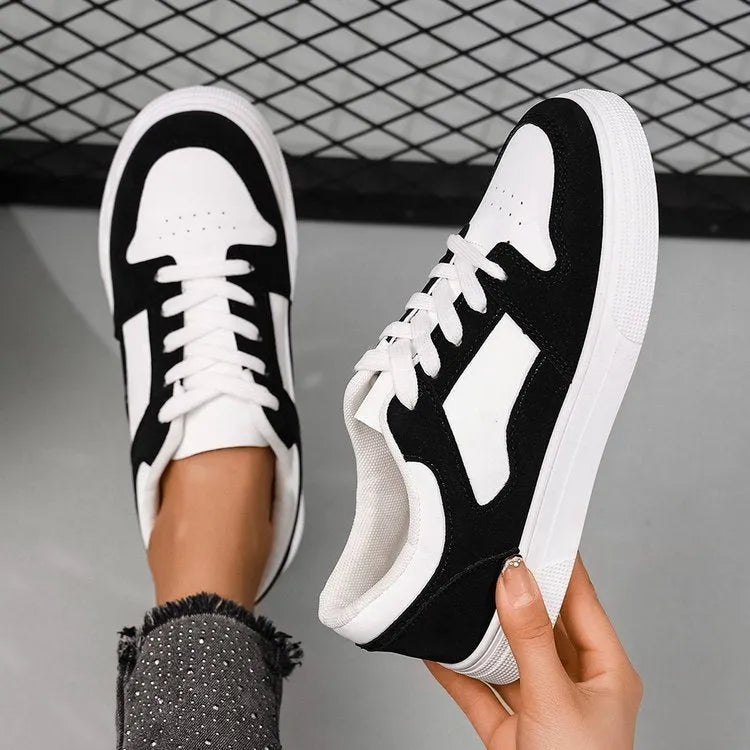 Black women's low-top casual sports shoes with a rubber sole and round toe.