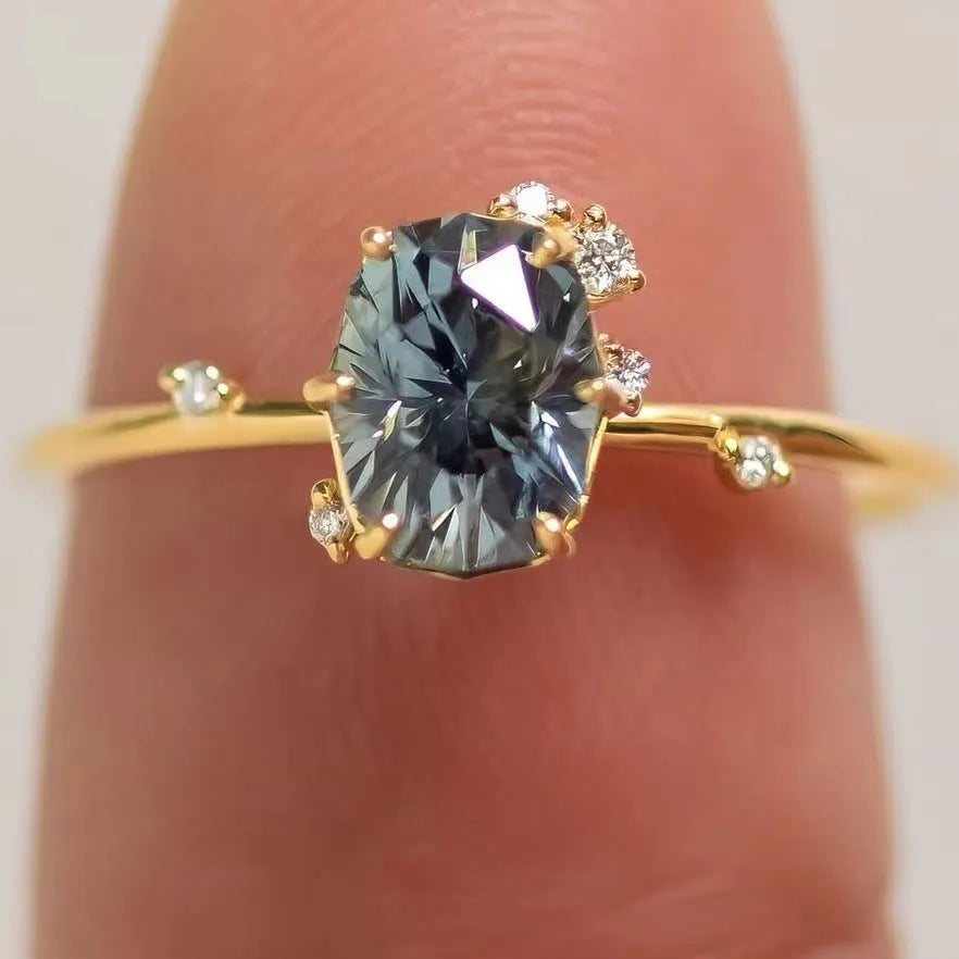 Gold plated women's ring with a green zircon stone set in a flower-shaped alloy band.