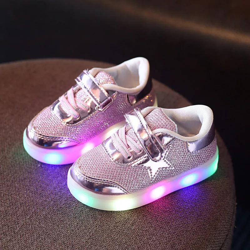 LED magic button sneakers in golden, pink, and silvery metallic finishes with illuminated soles