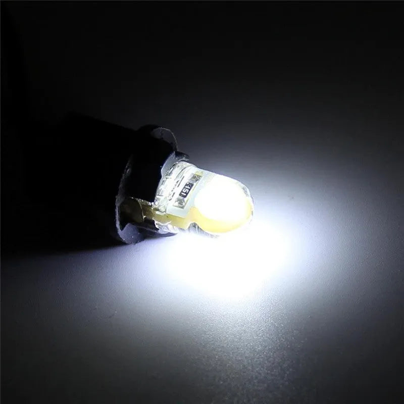Pack of ten T10 wedge base LED bulbs for 12V car lighting in various colours on a white background.