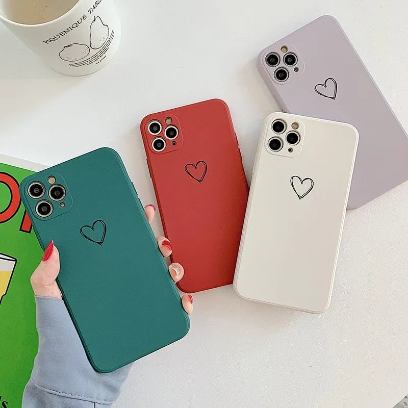 Solid colour silicone phone case for iPhone shown in black, green, grey, light green, pink, purple, red, and white options
