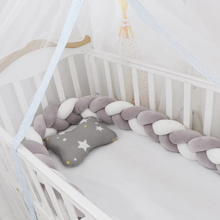 Baby crib bumper protector in spandex velvet, bent to show flexible shape, against a crib rail.