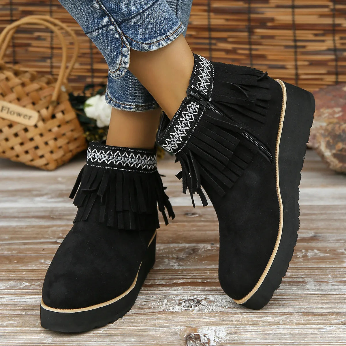 Women's dark brown suede ankle boots with a thick wedge sole, side zip, and decorative tassel.