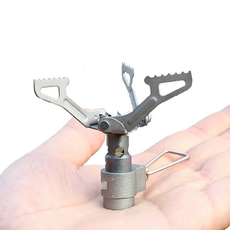 Portable propane gas camping stove with a one-piece metal furnace structure.