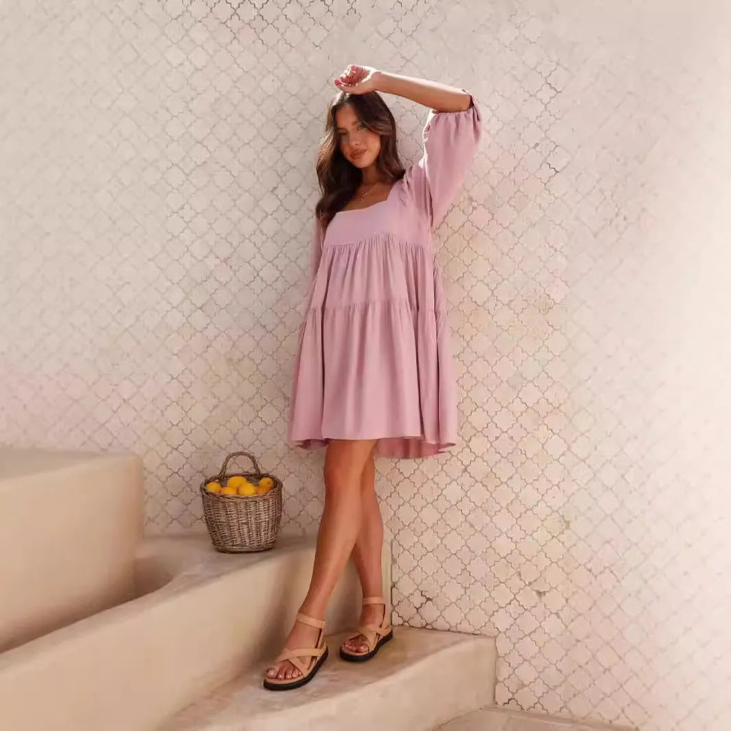 Orange children's backless dress with a square collar and puff sleeves, showing A-line skirt.