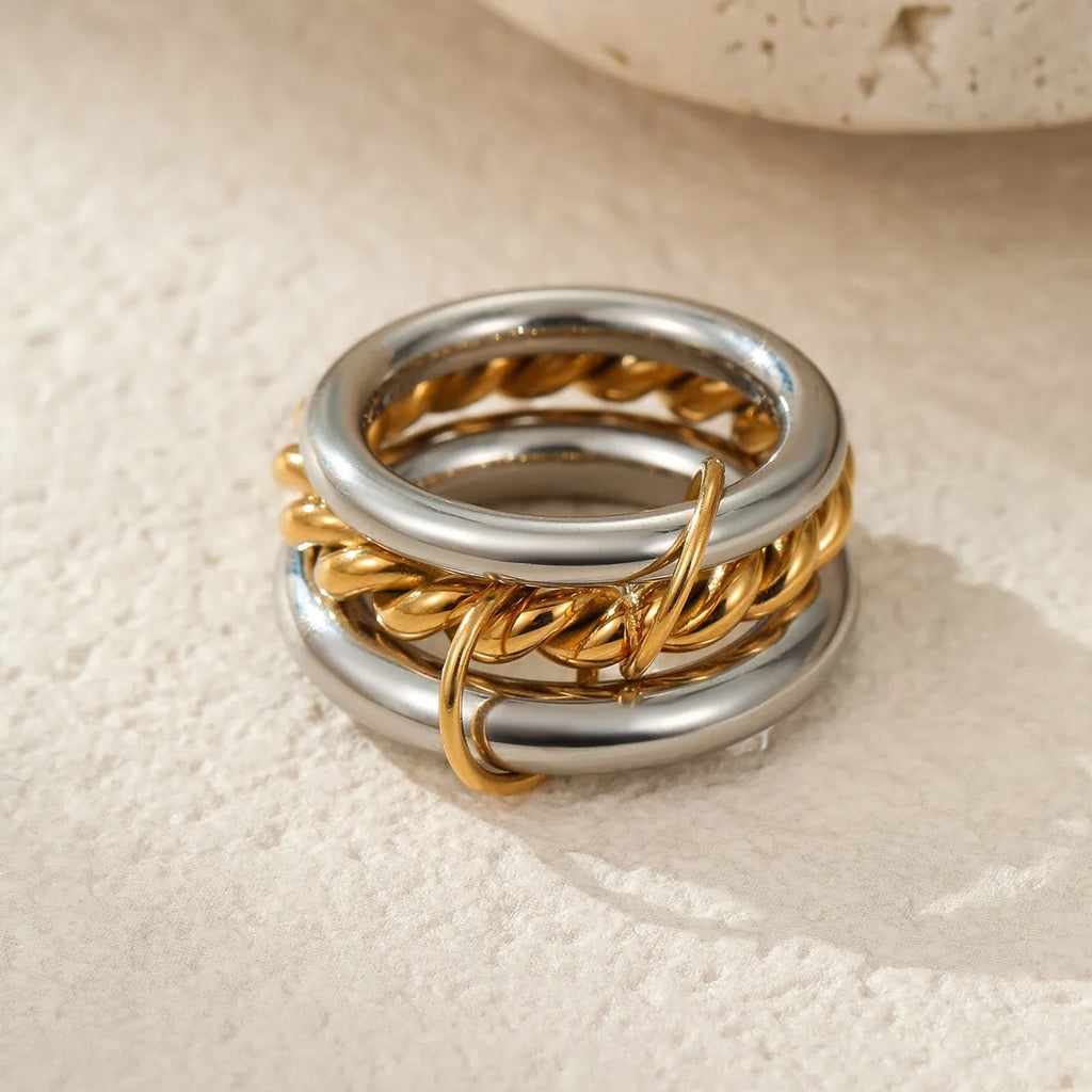 Three gold-plated geometric stacking rings with adjustable free size on hand