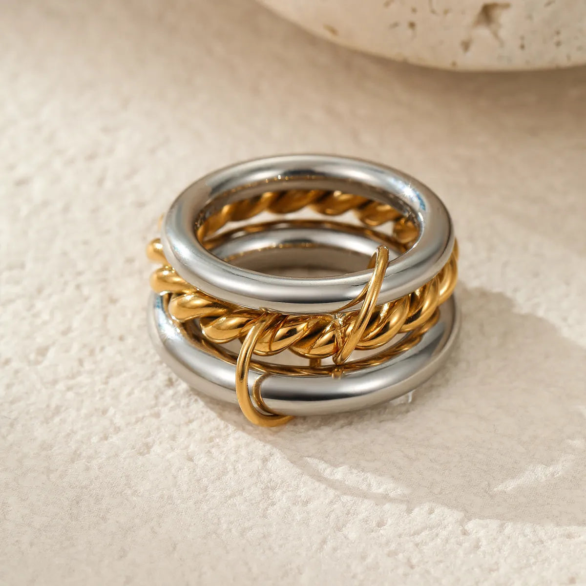 Three gold-plated geometric stacking rings with adjustable free size on hand